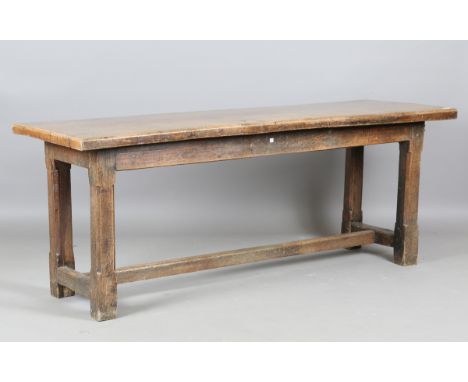 A 19th century oak refectory table, made from some earlier elements, the single-plank top on chamfered block legs, height 72c