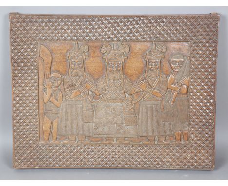 A Benin carved hardwood panel, finely modelled in low relief with a ceremonial scene of five figures, 59cm x 78cm.Buyer’s Pre