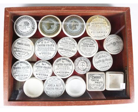 A small collection of late Victorian and early Edwardian paste pot lids, further small pots, a table-top glazed mahogany disp