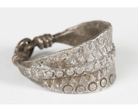 A Viking silver finger ring of tapering bezel form, with all-over incised dot and triangular designs, width 2.4cm. Note: from