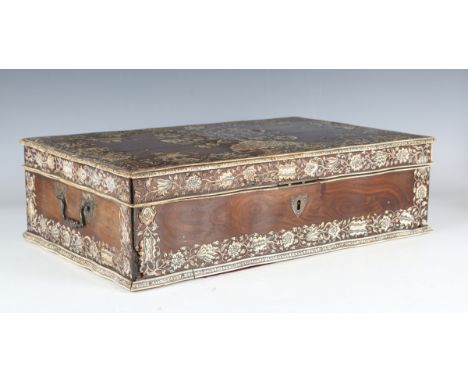 A late 18th century Indo-Portuguese hardwood and ivory inlaid workbox, the serpentine shaped lid with a central spray of flow