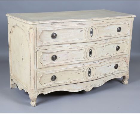 An 18th century French cream painted walnut serpentine fronted three-drawer commode, on carved squat legs, height 86cm, width