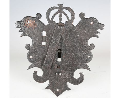 A 17th century wrought iron lock plate, the central crown flanked by two symmetrical stylized birds, height 21cm.Buyer’s Prem