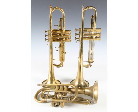 A Conn brass '52 B' trumpet, serial number '709295', cased, a Boosey trumpet, a Lark cornet and a brass trombone by Jupiter, 