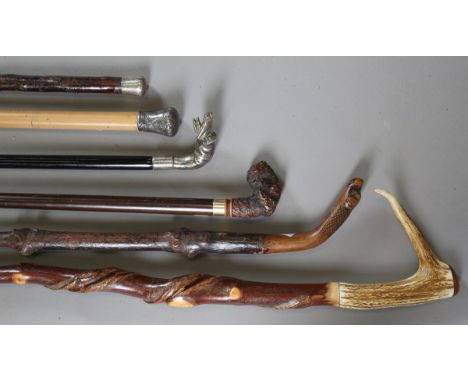 A 20th century ebonized walking cane with silver plated dog's head handle, length 92cm, another walking cane with resin dog's