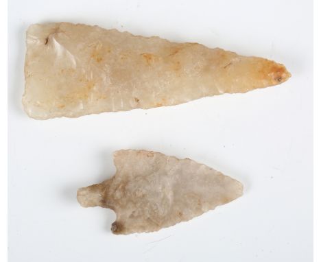 A Neolithic chipped flint arrowhead, possibly British, length 4cm, together with another Neolithic flint arrowhead, length 6.