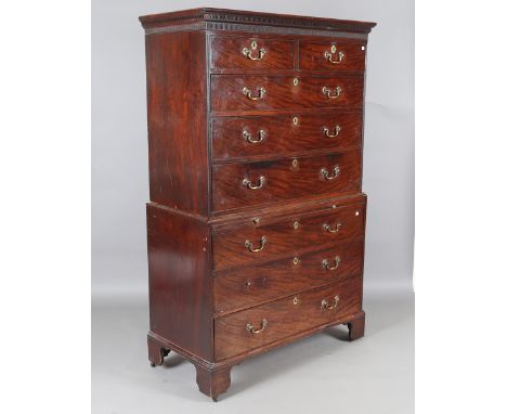 A George III mahogany chest-on-chest, the oak-lined drawers with brass drop handles, fitted with a central brushing slide, he