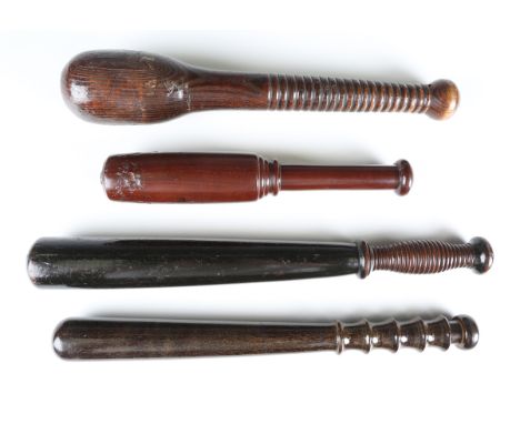 A Victorian ebonized wooden policeman's truncheon of tapering form with a shaped ribbed handle, length 41cm, an early 20th ce