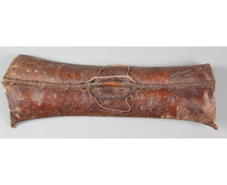 A Karamojong cowhide shield, Uganda, the concave rectangular panel with central ridge and handle, height 78cm, width 30cm.Buy