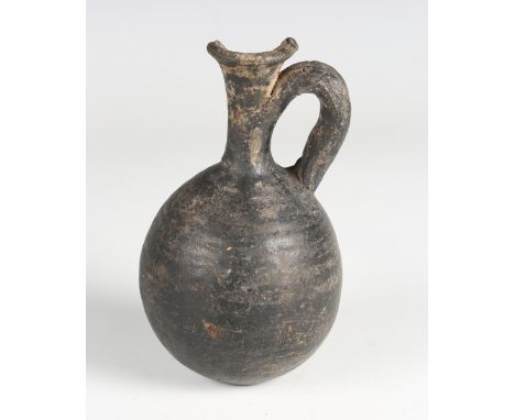 A Greek black pottery flask with flared neck and loop handle, height 13.5cm (faults). Provenance: Bonhams, 7th Nov 2022, Lot 