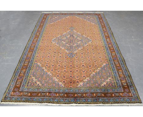 A Bidjar carpet, North-west Persia, late 20th century, the terracotta field with a shaped medallion, profusely supported by h