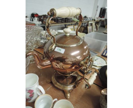 A copper kettle on stand with ceramic handles
