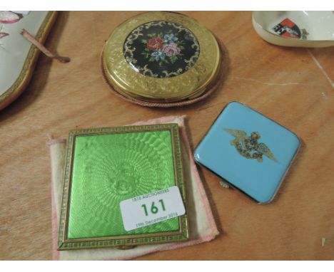 Two engine tooled compacts with floral and gouache design and another enamelled with RAF emblem
