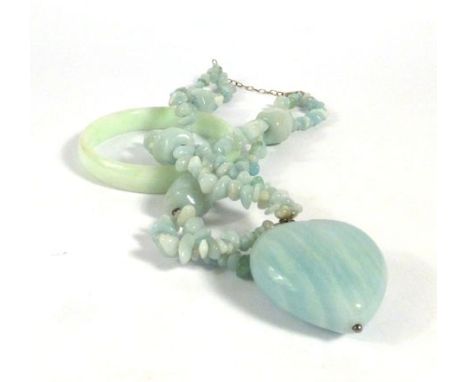 A pale green jade bangle and a similar pendant necklace (2)   CONDITION REPORT:   