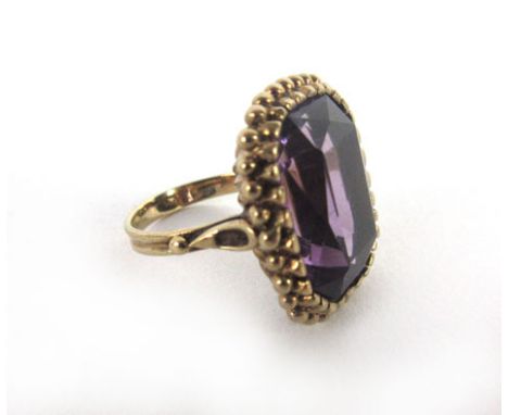 A 9ct yellow gold ring set rectangular cut amethyst within a double milliegrain type setting,ring size H 1/2,6.6 gms