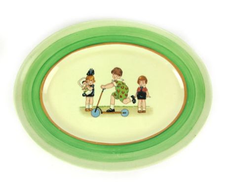 Clarice Cliff for Newport Pottery, an oval platter, later applied with a transfer print of children at play, 29 x 23 cm