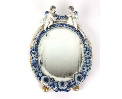 A 19th century ceramic continental Meissen style oval bevel glass mirror with painted blue parallel lines with crossed line m