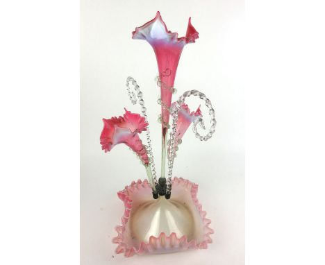 A Victorian cranberry glass epergne with a central flute surrounded by two smaller flutes and two spiral twists, h. 54 cm