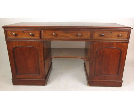 A Victorian mahogany dressing table/desk, the top over three drawers above kneehole with shelf flanked by two cupboards. h. 7