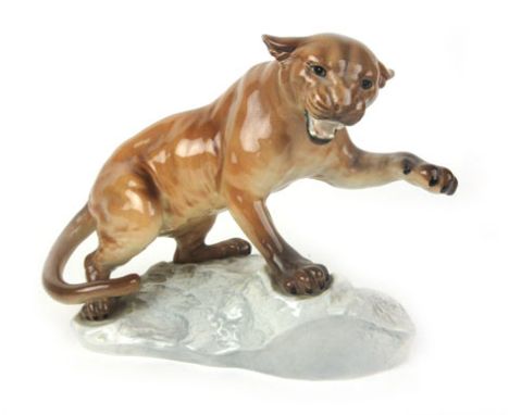 A large Beswick ceramic figure of a Puma on rocks No.1702, with glazed finish h. 21cm   CONDITION REPORT:  In need of a clean