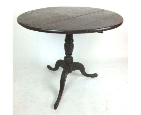 A 18th century oak tilt top tripod table, the circular top on turned column and three splay legs, h. 73 cm, dia. 80 cm.   CON