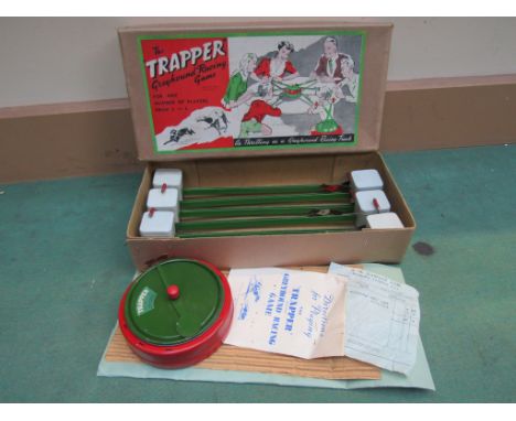 A boxed "The Trapper" tinplate greyhound racing game with instruction book and original receipt 