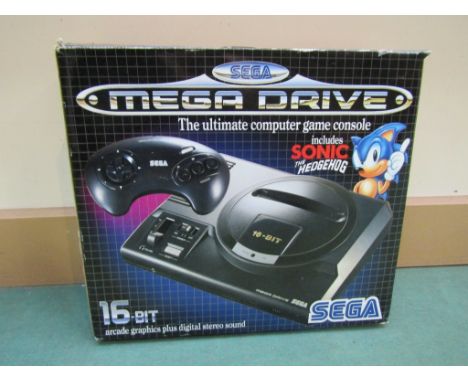 A boxed Sega Mega Drive games console with Sonic The Hedghog game, controller, leads and manuals