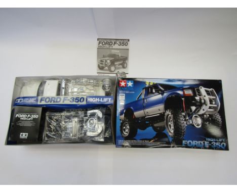 A boxed Tamiya 1/10 scale radio controlled Ford F350 High-Lift 4x4 pick-up truck model kit 