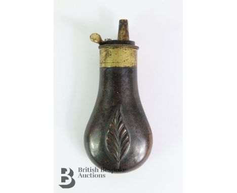 Small bag-shaped powder flask, with impressed foliate design, approx 10 cms. Note: Collection of a gentleman one of the first