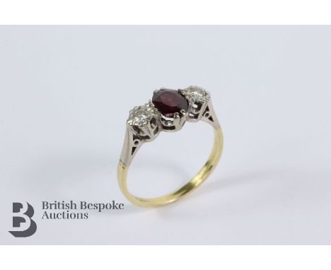 18ct yellow gold, platinum, garnet and diamond ring. The ring set with an oval garnet 7 x 5 mm, flanked by 12 pts of dias, si