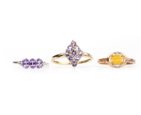 THREE GEM SET RINGS, including one with a rhombic bezel set with round faceted lilac gems, size R, all in nine carat gold, 5.