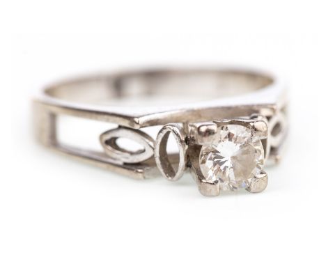DIAMOND SOLITAIRE RING, with a high set four claw mounted round brilliant cut diamond of approximately 0.29 carats, on pierce
