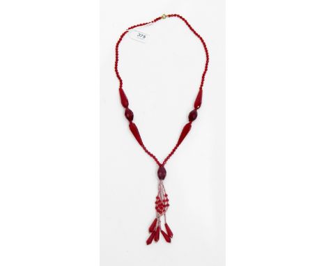 Vintage red glass bead necklace with faceted beads of varying shades of red and with central tassel 