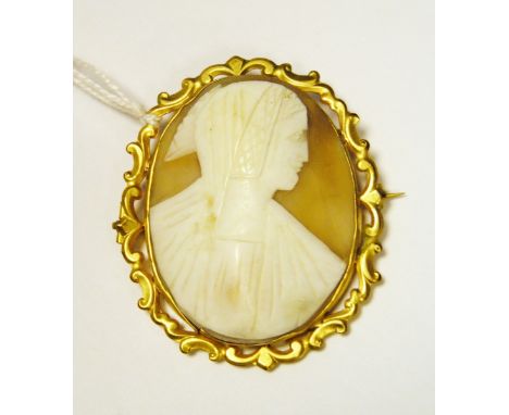 Victorian gold-coloured metal and shell cameo brooch, oval, medieval head and shoulders portrait with rococo scroll openwork 