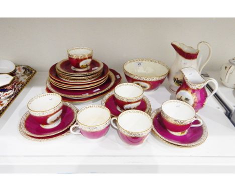 Victorian part tea service, purple ground, gilt decorated with landscape scene 