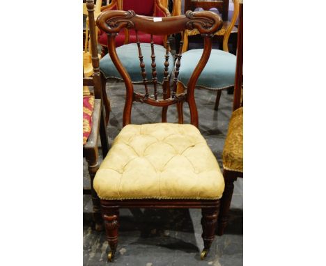 Late Victorian mahogany-framed nursing chair with turned spindle back, carved and shaped crest rail, button upholstered seat,