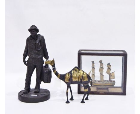 Bronze-effect model of a man carrying a suitcase, a model of HMS Bounty in glazed case and a metal model of a camel (3) 