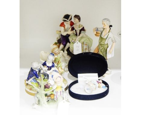 German porcelain figure group of a courting couple, 17cm high, with blue crowned 'K' mark to base, a Goebel figure of a gentl