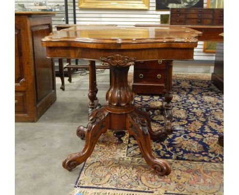 Victorian rosewood card table with hinged top, on quadruped carved cabriole legs and castors, 90cm wide 