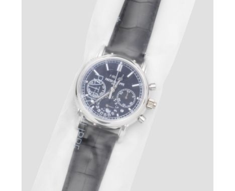 Patek Philippe. A very fine and rare factory sealed platinum manual wind split second chronograph perpetual calendar wristwat