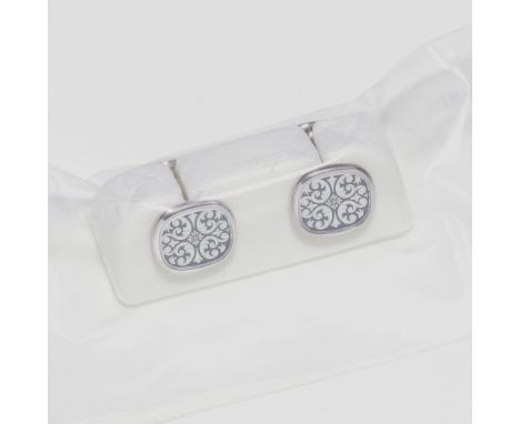 Patek Philippe. A set of factory sealed 18K white gold and black enamel cuff linksModel: Golden Ellipse 50th AnniversaryDate: