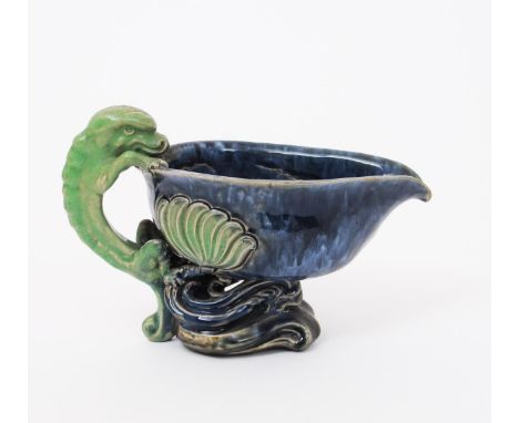 A Doulton stoneware jug probably by Mark V Marshall, the elliptical bowl raised up on pierced Art Nouveau flower stem foot, t