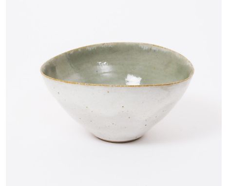 ‡ Dame Lucie Rie D.B.E (1902-1995) a stoneware flaring elliptical bowl, the interior glaze pale celadon, the exterior a speck