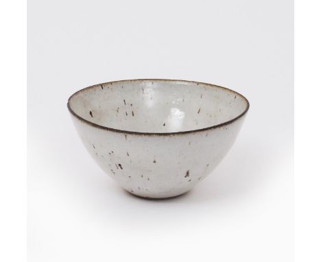 ‡ Dame Lucie Rie D.B.E (1902-1995) a stoneware bowl glazed to the foot with a pale grey glaze with manganese speckles and dri