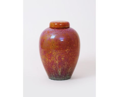 An impressed Pilkington's Lancastrian ginger jar and cover, tall, slender form covered in a curdled orange and red lustre gla