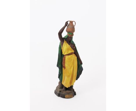 A Goldscheider Pottery figure of a water carrier, model no.875, modelled as female Nubian carrying a water-jar on her head,  