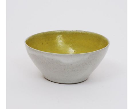 ‡ Dame Lucie Rie D.B.E (1902-1995) an early stoneware bowl, flaring slightly elliptical form, glazed yellow to the interior, 