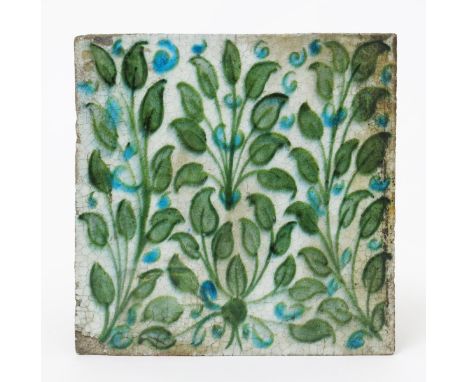 A William De Morgan Chelsea Period tile, painted with clumps of foliage in green and turquoise blue on a white ground impress