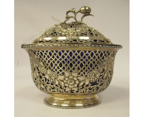 A reproduction of a Georgian silver latticeworked, floral and scroll cast and chased oval pot pourri bowl and domed cover wit