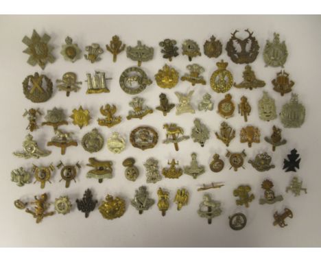 Approx. sixty military cap badges and other insignia, some copies: to include Royal Dublin Fusiliers, The Royal Irish, Army E